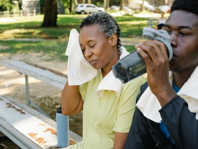 Refreshing water and towel on a white bench